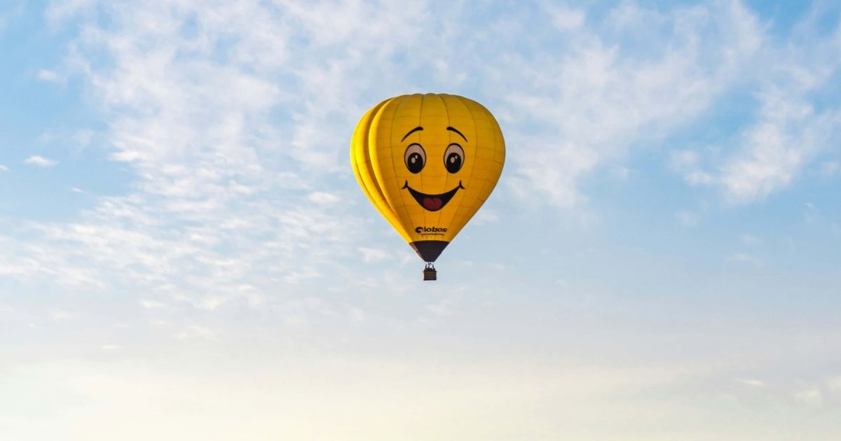 yellow happy face hot air balloon symbolizing teacher empowerment